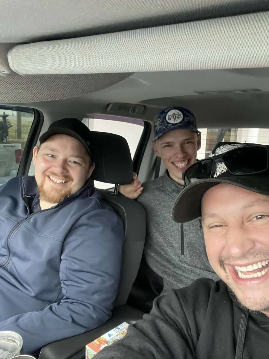 Three Flag Gutter crew members in the work truck between jobs