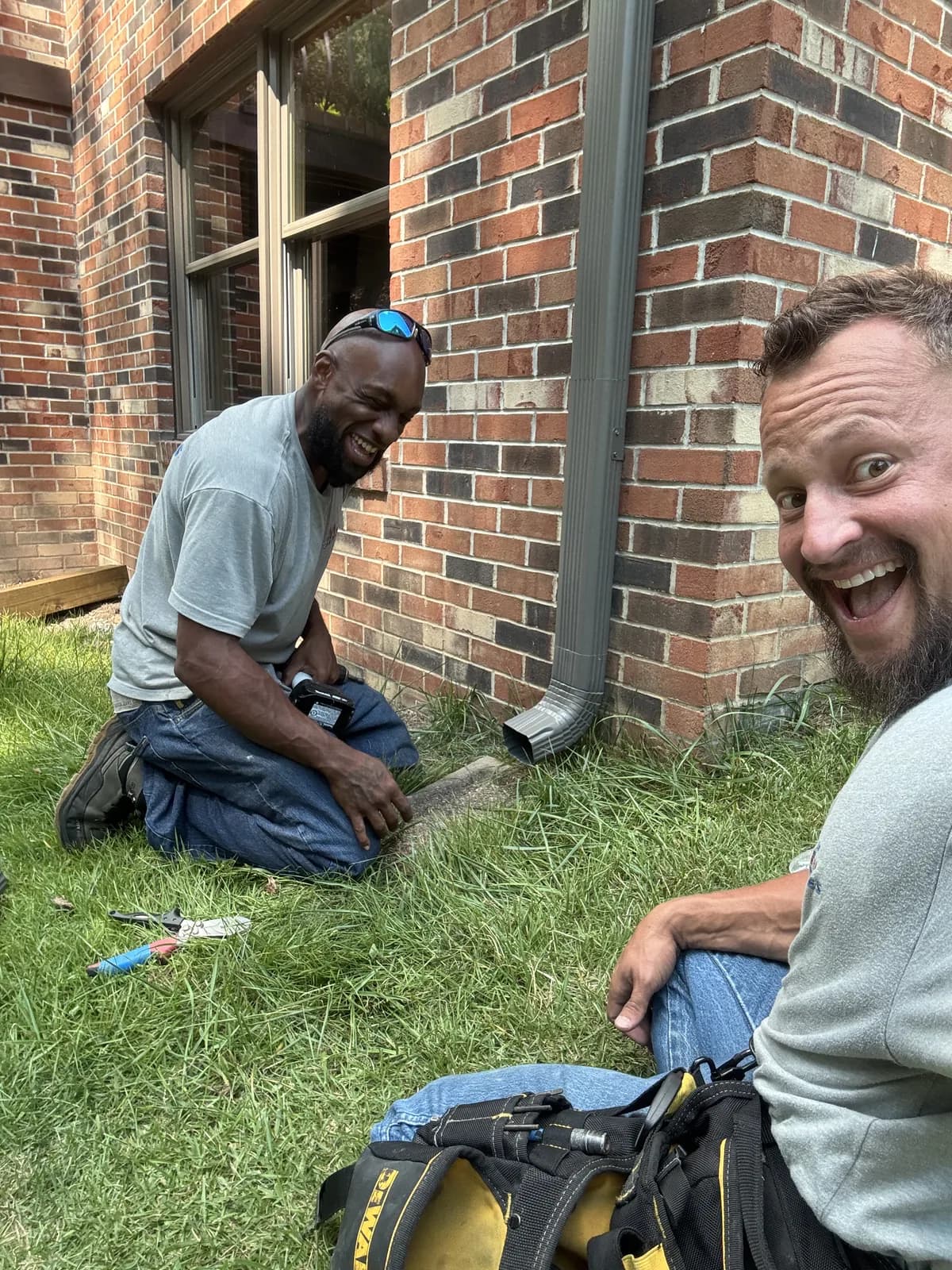 Christiaan, Flag Gutter's founder, with a crew member finishing a downspout