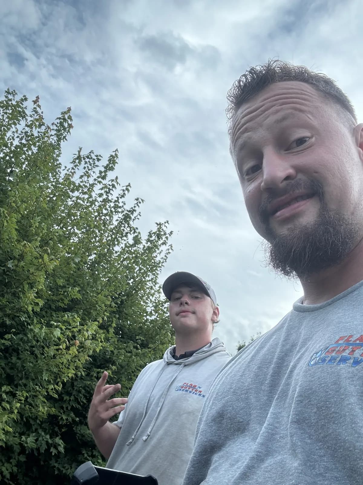 Christiaan and a Flag Gutter crew member on a job site