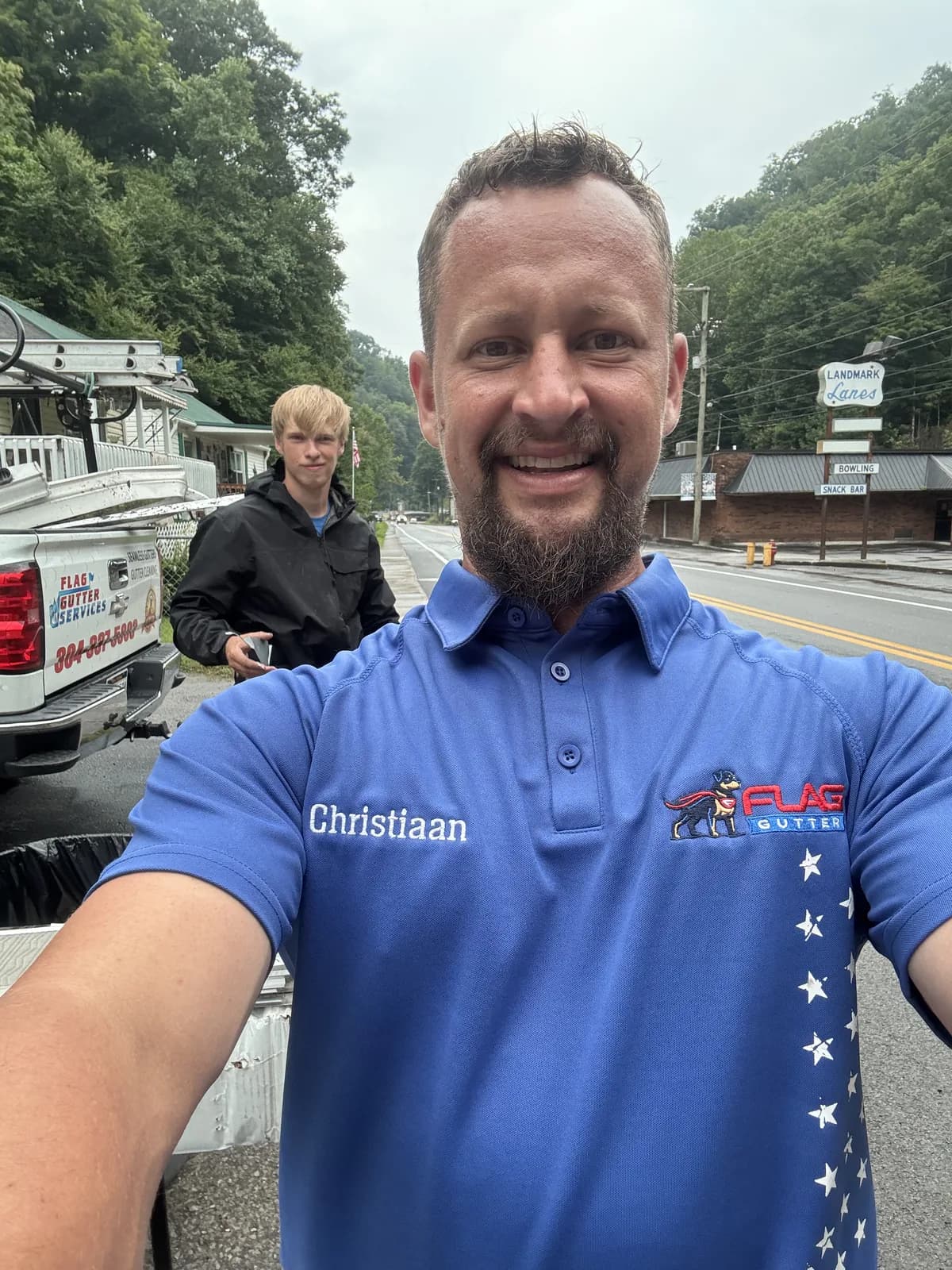 Christiaan, founder of Flag Gutter, in a Flag Gutter polo on a job site