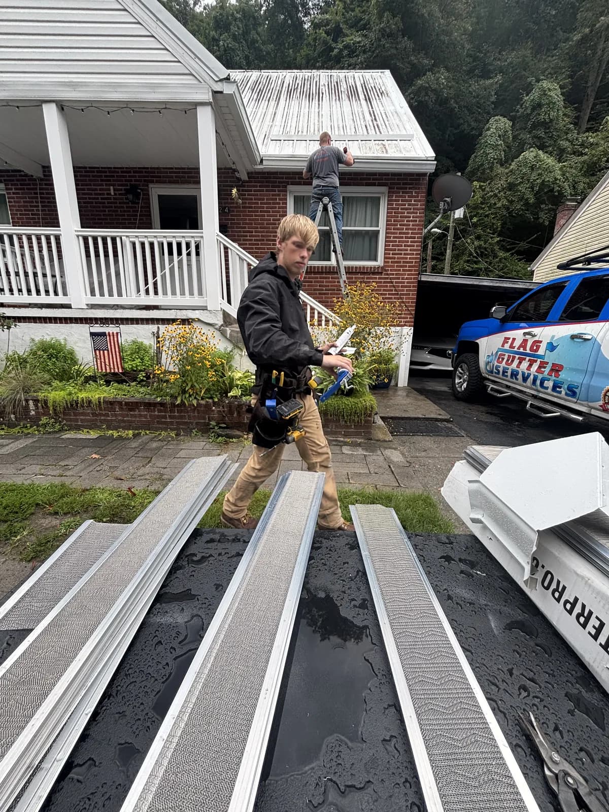 Seamless gutter runs formed on site beside the Flag Gutter truck