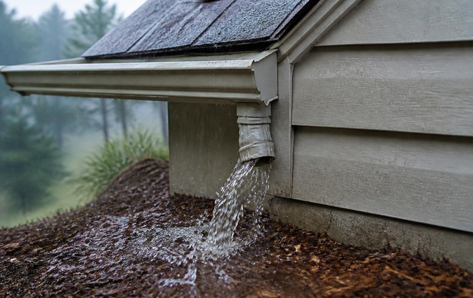 Water leaking from a gutter corner during a heavy West Virginia summer rainstorm