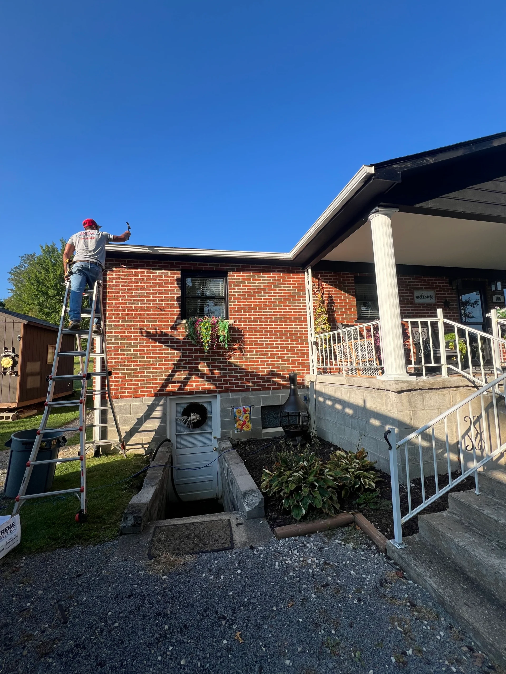 gutter cleaning service in progress with workers using equipment to clear debris ensuring proper drainage and maintenance in hinton wv