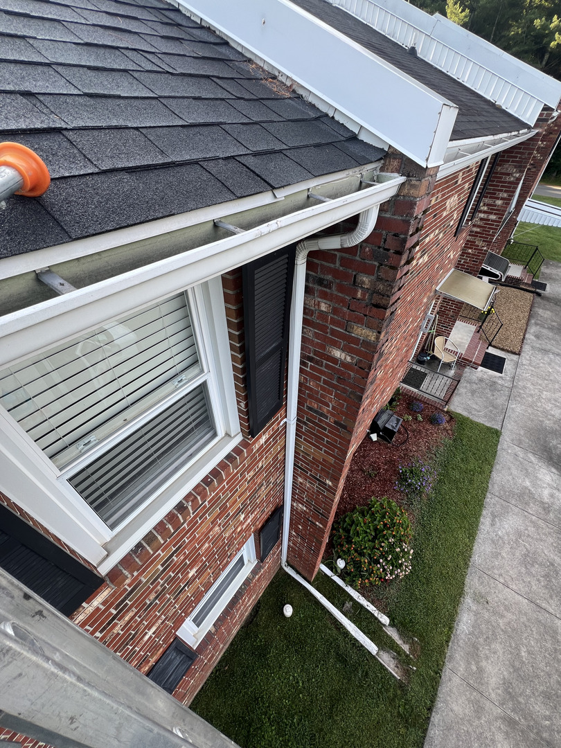 gutter cleaning services with a focus on removing debris and ensuring proper water flow from the roof system